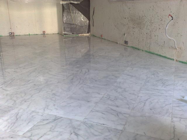 Process of facing of a floor by marble tile Bianco Carrara, Italy  =>Following