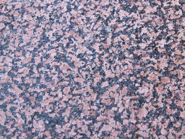 The paving slabs of red granite Balmoral Red thermo treated