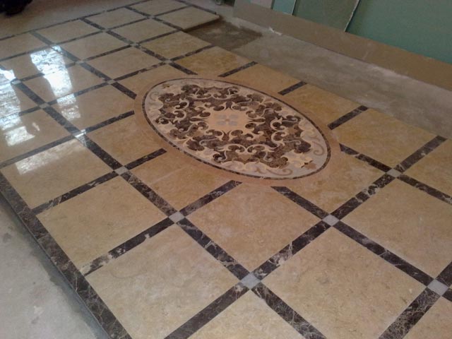 Facing of a floor by marble with mosaic drawing  =>Following